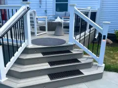 A beautifully lit deck staircase, showcasing how to build deck stairs with integrated lighting and non-slip mats.
