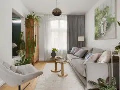 Przytulny salon w domu z szarą kanapą, wygodnym fotelem i mnóstwem zielonych roślin.