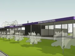 Nowa myjnia bezdotykowa z fioletowym dachem, otoczona drzewami, z widoczną odległością od budynku mieszkalnego.