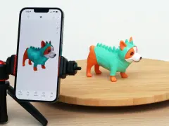 A phone on a tripod captures a toy dog, demonstrating 3D scanning for 3D printing.