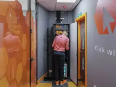Technician working on network infrastructure services in a server room.