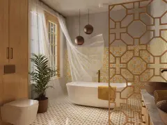 Élégante salle de bain style marocain avec baignoire, double vasque en cuivre, boiseries et carrelage ornemental.