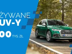 Zielony SUV na drodze w lesie. Używane SUV-y do 100 tys. zł.