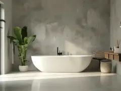 Bagno moderno con vasca freestanding e lavabo sospeso. Le pareti effetto resina creano un'atmosfera zen.
