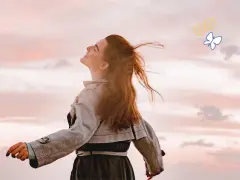 Embracing the sky, a woman with flowing red hair embodies joy, a feeling achievable through 7 daily habits. A butterfly and smiley faces float above.