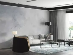 Nowoczesny salon z sofą, stolikami i dywanem. Ściana za sofą ma subtelny **efekt betonu**, nadając wnętrzu industrialny charakter.