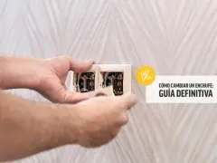 Man's hands carefully work on an electrical outlet, demonstrating how to change a plug.