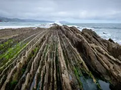 Dramatic rock formations on a rugged coastline, a perfect spot for day trips from Bilbao.
