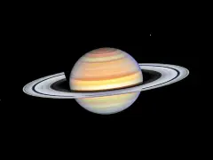 Saturn w Byku, majestatyczny gazowy olbrzym z pierścieniami, unoszący się w kosmicznej pustce.