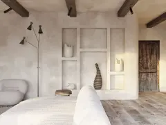 Wnętrze w stylu wabi sabi z drewnianymi belkami, tynkowanymi ścianami i rustykalnymi dekoracjami.