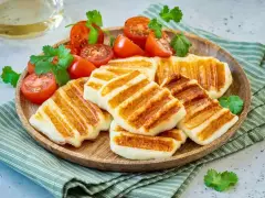 Grillowany ser halloumi z pomidorkami koktajlowymi i kolendrą. Idealny pomysł, co zrobić z sera halloumi na lekki posiłek.