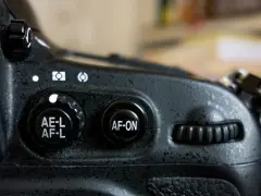 Gros plan sur un appareil photo, montrant le bouton "AF-ON" pour le **back button focus**.