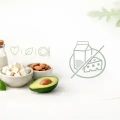 Mleko, ser, migdały, awokado, bazylia i ikony symbolizujące dietę bez laktozy.