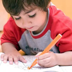 Bambino iperattivo concentrato a colorare, un'idea per cosa fare con un bambino iperattivo.