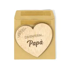 Cuore di legno con scritta "Diventerai... Papà", un dolce annuncio di gravidanza in una busta marrone.