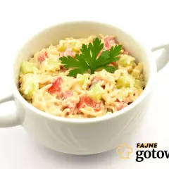 Pyszna sałatka z zupek chińskich z szynką, pomidorkami i ogórkiem, udekorowana natką pietruszki.
