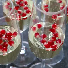 Elegancki drink z szampanem i nasionami granatu, gotowy na toast.