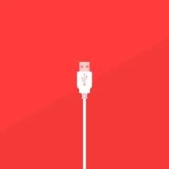 Un conector blanco de varios tipos USB se alza sobre un fondo rojo vibrante, listo para conectar.