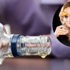 Kropla spirytusu kapie z butelki. W okręgu kobieta z młoteczkiem neurologicznym.