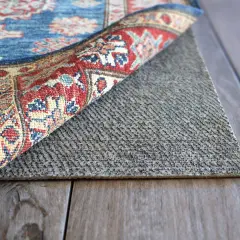 A rug is flipped to reveal its backing, showing how to waterproof a rug with a protective layer.