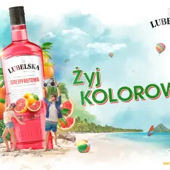 Lubelska litr grejpfrutowa na plaży, z ludźmi tańczącymi i balonami na niebie. Żyj kolorowo!
