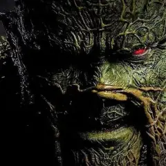 Gros plan sur le visage terrifiant de Swamp Thing, avec son œil rougeoyant. L'image évoque la saison 2 de Swamp Thing.