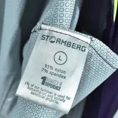 Metka odzieży marki Stormberg, firmy wspierającej projekty humanitarne. Rozmiar L, skład 93% nylon, 7% spandex.