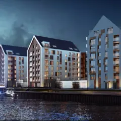 Nowoczesne apartamentowce nad wodą w Gdańsku, przy ulicy Chmielnej. Widok z rzeki na budynki i zacumowane jachty.