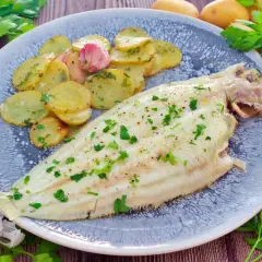 Delicioso lenguado al horno con patatas panadera y ajo. Un plato principal ligero y sabroso.