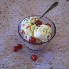 En skål med krämig glass, toppad med körsbär och bitar av frukt. En perfekt cassata glass för en varm dag.