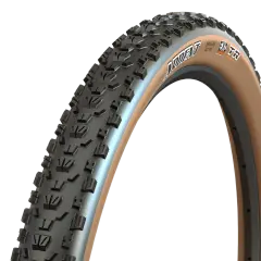 A close-up of a Maxxis Ardent tire with tan sidewalls, ready for a trail review. Its aggressive tread promises grip.