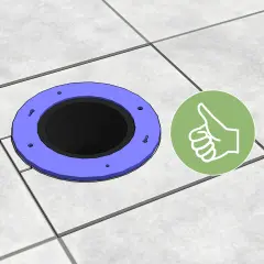 A toilet flange sits on tiled flooring, showing how to cut tile around toilet for a perfect fit. A green thumbs-up icon indicates success.
