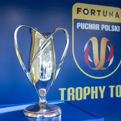 Błyszczący puchar Fortuna Pucharu Polski na tle niebieskiej ściany z logo i napisem "Trophy Tour".