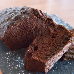 Pyszny, wilgotny murzynek pokrojony w plastry, oprószony cukrem pudrem. Idealny na deser.
