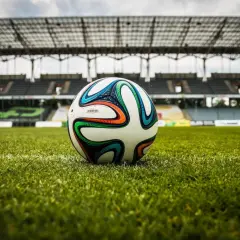 Piłka na murawie stadionu, gotowa do gry. Czekamy na sygnał, by dowiedzieć się, ile trwa dogrywka w piłce nożnej.