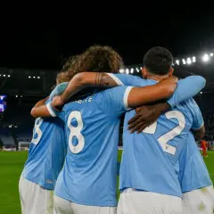 Piłkarze Lazio świętują bramkę w meczu z A.C. Milan. Stadion wypełniony kibicami, na tablicy wyników "GOAL".
