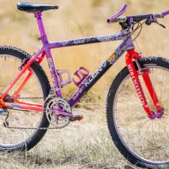 A vibrant Klein Adroit mountain bike with purple and orange fade paint, ready for an adventure.