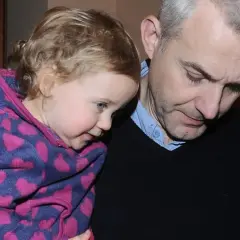 Hubert Urbański z córką, która przytula się do niego w bluzie w serduszka.