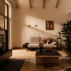 Nowoczesny salon z kamiennym kominkiem, dwoma sofami, drewnianą podłogą i dużą rośliną. Inspiracje dla Twojego salonu.