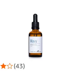 En flaska "Wavy Hair Oil" med pipett, perfekt för att ge näring och glans till torrt hår.