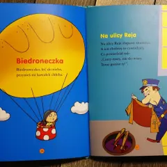 Otwarta książka z ilustracjami: biedronka w balonie i policjant przy studzience. Wierszyki dla dzieci.
