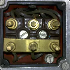 Terminal box showing wiring for how to podłączyć silnik 3 fazowy 5 przewodów. Widać zaciski U, V, W i mostek.
