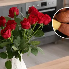 Piękne, czerwone róże w białym wazonie, a obok zapałki gotowe do rozpalenia ognia.