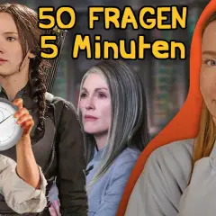 Die Besetzung von Die Tribute von Panem: Jennifer Lawrence, Woody Harrelson, Julianne Moore und eine nachdenkliche Frau. Ein Stoppuhr-Symbol deutet auf eine Zeitfrage hin.