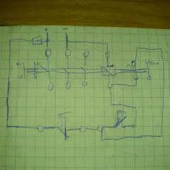 Schematyczny rysunek przedstawia budowę stycznika z cewką i stykami, połączony z elementami wykonawczymi.