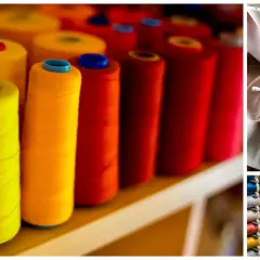 Bobines de fil métallique utilisé dans les textiles, aux couleurs vives. Un mètre ruban et des ciseaux sur un tissu rose pâle.