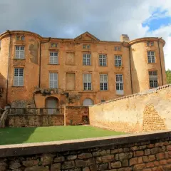 Château de Oingt, joyau du circuit des pierres dorées, se dresse fièrement sous un ciel orageux.