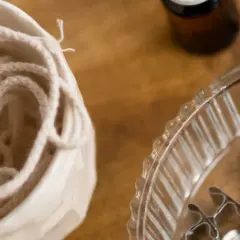 Bawełniany sznurek w ceramicznym naczyniu i metalowe stopki do knotów – idealne, by dowiedzieć się, z czego zrobić knot do świeczki.