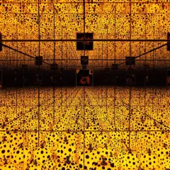 A dazzling infinity room with crystal bridges, bathed in golden light and adorned with Yayoi Kusama's iconic polka dots, creating an endless, mesmerizing spectacle.