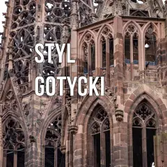 Kamienna katedra z ostrymi łukami, rozetami i gargulcami. Widoczne są charakterystyczne cechy stylu gotyckiego: strzelistość, bogactwo detali i monumentalność.